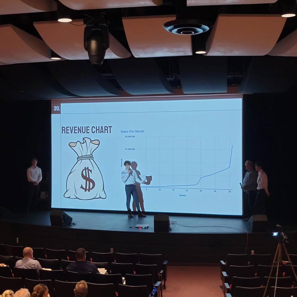 student presenting on stage